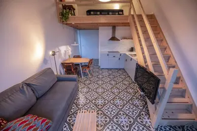 a living room with a couch and a table at 't Winkeltje - Vakantiehuisje op boerderij Huize Blokland in Hem