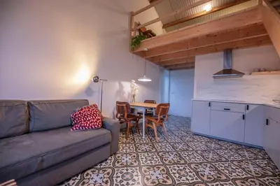a living room with a couch and a table at 't Winkeltje - Vakantiehuisje op boerderij Huize Blokland in Hem