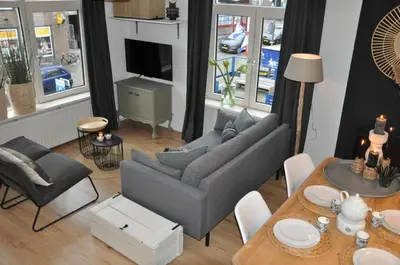 a living room with a couch and a table at Sunny Reef in Egmond aan Zee