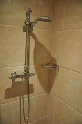 a shower with a shower head in a bathroom at Sunny Reef in Egmond aan Zee