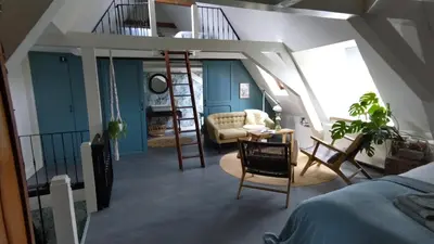 a bedroom with a loft bed and a living room at Bed & Breakfast [H]eerlijk! in De Kwakel