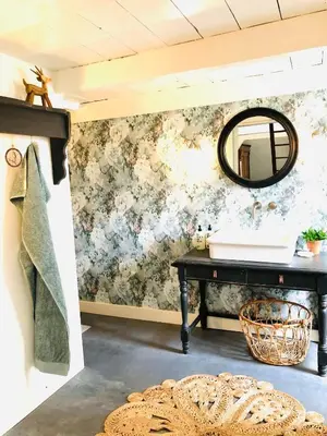 a bathroom with a sink and a mirror on a wall at Bed & Breakfast [H]eerlijk! in De Kwakel