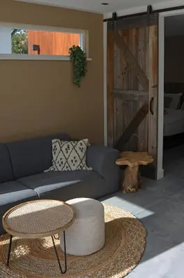 a living room with a couch and a table at Olive Beach, luxury beachhouse 150 m from the beach in Noordwijk aan Zee