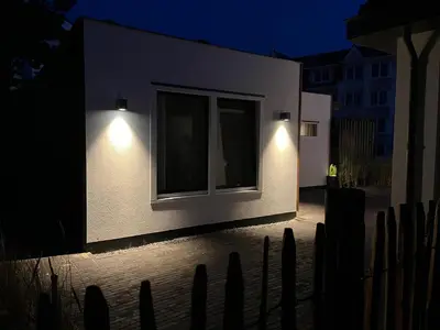 a building with lights on the side of it at night at Olive Beach, luxury beachhouse 150 m from the beach in Noordwijk aan Zee