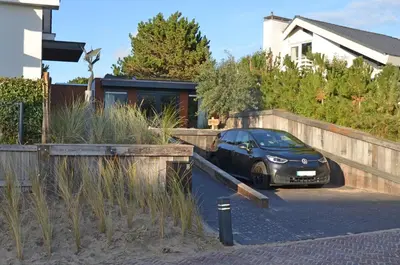a black car parked in front of a house at Olive Beach, luxury beachhouse 150 m from the beach in Noordwijk aan Zee