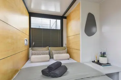 a room with a bed with two pillows on it at Cosy tiny houseboats near beach and restaurants by Weltevreden Experience in Zeewolde