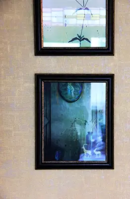 two framed pictures hanging on a wall at House of Freddy in Amsterdam