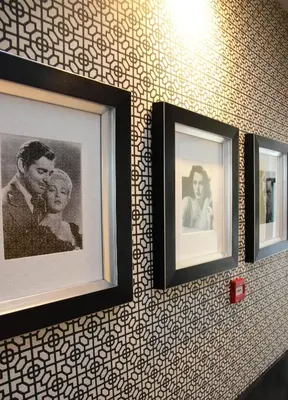 three framed pictures of a man and a woman on a wall at House of Freddy in Amsterdam