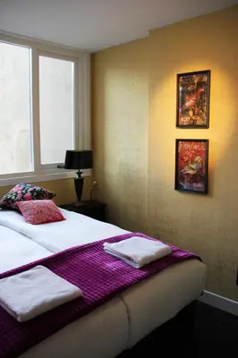 a bedroom with a bed with towels on it at House of Freddy in Amsterdam