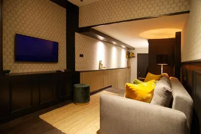 a living room with a couch and a flat screen tv at House of Freddy in Amsterdam