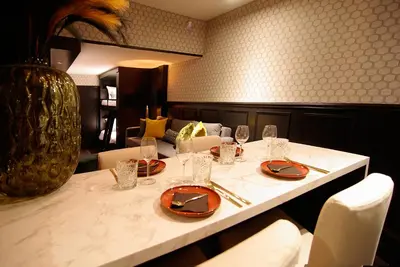 a table in a restaurant with plates and wine glasses at House of Freddy in Amsterdam
