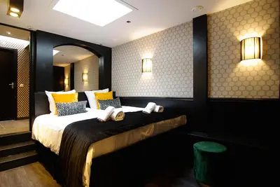a bedroom with a large bed with yellow pillows at House of Freddy in Amsterdam