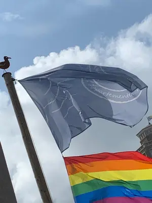 a rainbow flag with a bird on top of it at Appartement 't Loft in Zandvoort