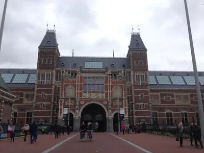 a large brick building with people walking in front of it at Appartement 't Loft in Zandvoort