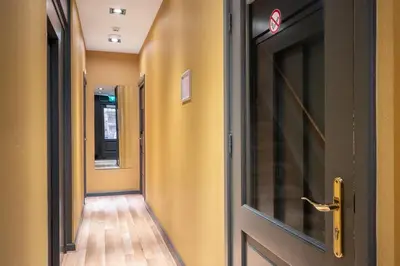 an entrance door to a hallway with a wooden floor at Musea Hotel & Apartments in Amsterdam