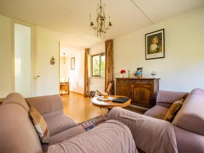 a living room with two couches and a table at Comfy holiday home in Hoorn with French balcony in Hoorn