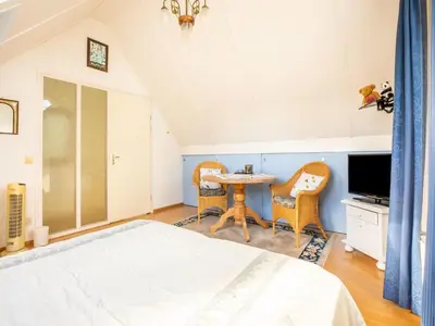 a bedroom with a bed and a table and chairs at Comfy holiday home in Hoorn with French balcony in Hoorn