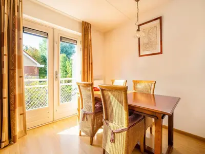 a dining room with a table and chairs and a window at Comfy holiday home in Hoorn with French balcony in Hoorn