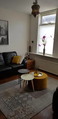 a living room with a couch and a table at Vakantiehuis Katwijk in Katwijk