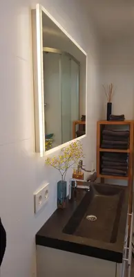 a bathroom with a sink and a mirror at Vakantiehuis Katwijk in Katwijk
