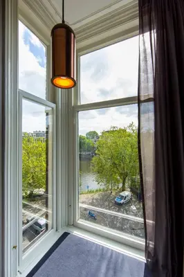 a window with a view of a river at No. 377 House in Amsterdam