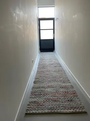 an empty hallway with a door and a rug at Studio 28A5 with free parking place in Amsterdam