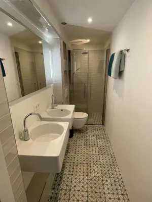 a bathroom with two sinks and a shower at Studio 28A5 with free parking place in Amsterdam