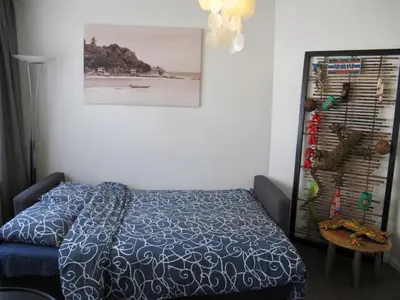 a bedroom with a bed and a picture on the wall at Bos en Lommer Hotel - Erasmus Park area in Amsterdam