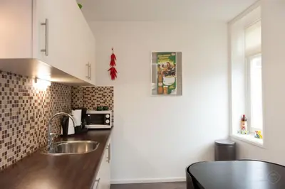 a kitchen with a sink and a counter top at Bos en Lommer Hotel - Erasmus Park area in Amsterdam