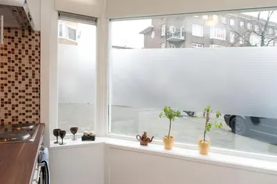 a kitchen window with potted plants on a window sill at Bos en Lommer Hotel - Erasmus Park area in Amsterdam