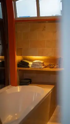 a bath tub in a bathroom with a window at Amsterdam Center - Houseboat by Captain Ricard in Amsterdam