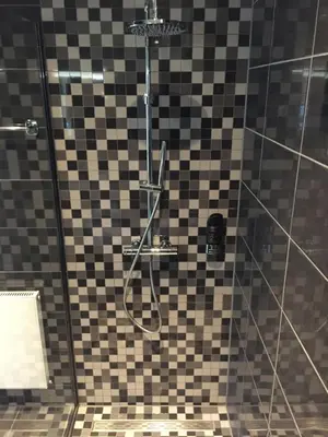 a bathroom with a shower with a glass at Golden Mansion Apartment Hotel in Amsterdam