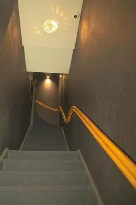 a set of stairs with a light on the ceiling at Golden Mansion Apartment Hotel in Amsterdam