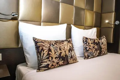a bedroom with a bed with two pillows at Golden Mansion Apartment Hotel in Amsterdam