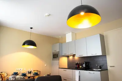 a kitchen with two lights hanging from the ceiling at Golden Mansion Apartment Hotel in Amsterdam