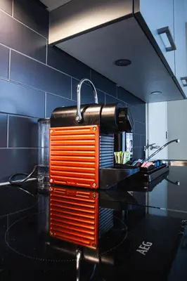 an orange and black appliance on a counter in a kitchen at Golden Mansion Apartment Hotel in Amsterdam