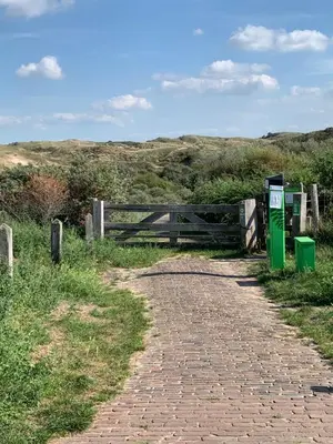a brick path with a gate and a fence at Zomerhuis Beach EnJoy in Egmond aan Zee