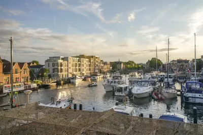 a group of boats docked in a marina at 2L De Volharding in Leiden