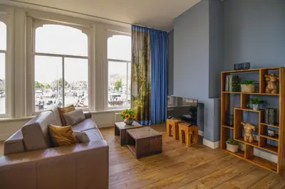a living room with a couch and a tv at 2L De Volharding in Leiden