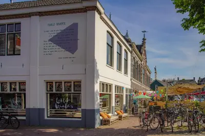 a white building with bikes parked outside of it at 2L De Volharding in Leiden