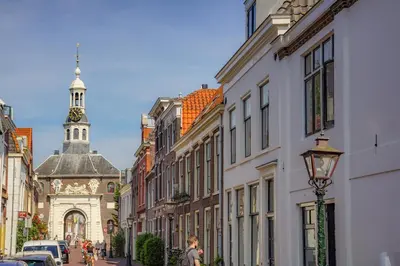 a city street with buildings and a clock tower at 2L De Volharding in Leiden