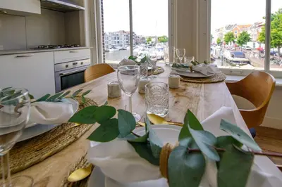 a dining room table with plates and glasses on it at 2L De Volharding in Leiden
