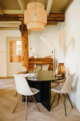 a dining room with a black table and white chairs at Luxe stolpboerderij vol sfeer én authentieke details voor 4 in Twisk in Twisk