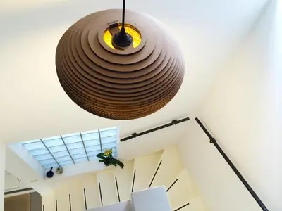 a large brownendant light hanging from the ceiling in a room at Romantic Wellness BnB Noordwijk in Noordwijk aan Zee