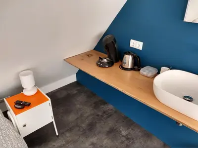 a room with a wooden counter with a sink at Hoogland aan Zee in Egmond aan Zee