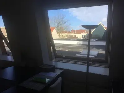 a window in a room with a table and a lamp at Studio, 21 minutes by bus to downtown Amsterdam in Purmerend