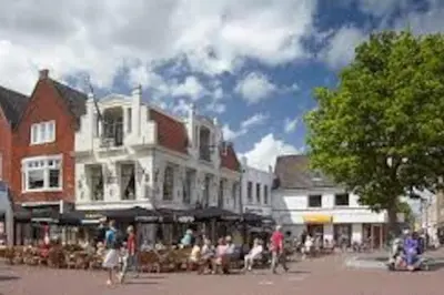 a group of people sitting on chairs in a city street at Studio, 21 minutes by bus to downtown Amsterdam in Purmerend