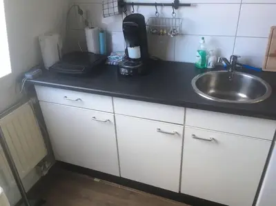 a kitchen with a sink and a counter top at Studio, 21 minutes by bus to downtown Amsterdam in Purmerend
