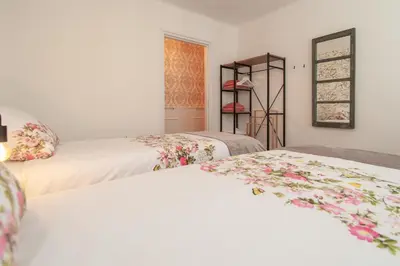 two beds in a room with white walls at CASASdeCASPER - Apartment Alkmaar in Alkmaar