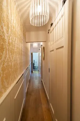 a hallway with a door and a chandelier at CASASdeCASPER - Apartment Alkmaar in Alkmaar